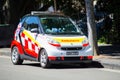 Little NSW Ambulance smart car parking on downtown street of Sydney.